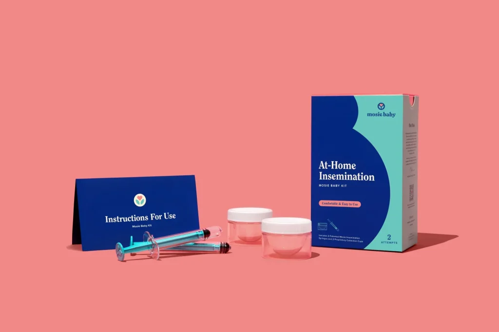 at-home insemination kit with syringes, collection cups, and instructions on a pink background