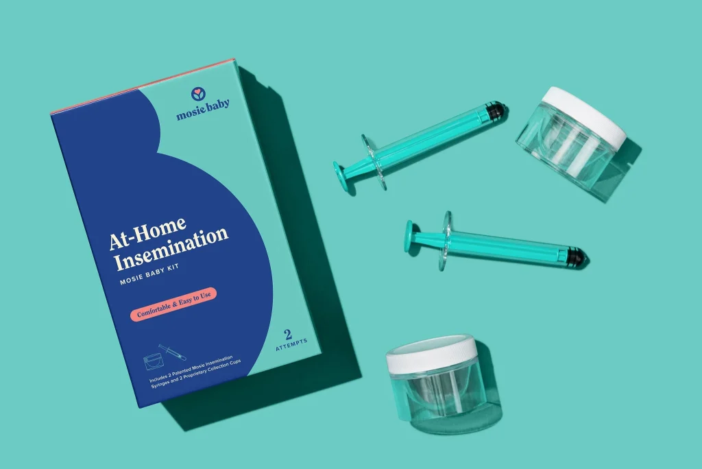 Mosie Baby kit for at-home insemination with syringes and collection cups on a teal background.